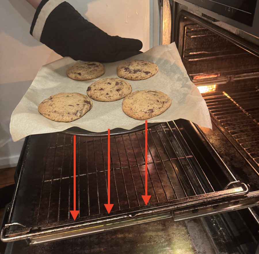 Cookies on a baking tray mid-bake